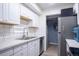 Updated kitchen with white cabinets, stainless steel appliances, and modern fixtures at 2557 S Dover St # 85, Lakewood, CO 80227