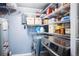 Practical laundry room featuring a washer, dryer, storage shelves, and a water heater at 2557 S Dover St # 85, Lakewood, CO 80227