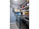 Functional laundry room with washer, dryer, and ample shelving for storage at 2557 S Dover St # 85, Lakewood, CO 80227