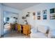 Bright room with large mirrors reflects an office workspace and comfortable sitting area at 2557 S Dover St # 85, Lakewood, CO 80227