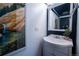 Chic powder room with a pedestal sink, modern mirror, and stylish decorative accents at 2557 S Dover St # 85, Lakewood, CO 80227