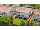 Aerial view of the backyard featuring a patio, green lawn, landscaping, and privacy fence at 15353 E 98Th Pl, Commerce City, CO 80022