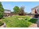 Grassy backyard featuring a patio and garden space, perfect for relaxation and outdoor activities at 15353 E 98Th Pl, Commerce City, CO 80022