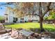 Expansive backyard featuring a lush lawn, mature trees, and a patio area for outdoor enjoyment at 15353 E 98Th Pl, Commerce City, CO 80022