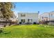 Large, fenced backyard with a well-maintained lawn and patio area, ideal for outdoor entertaining at 15353 E 98Th Pl, Commerce City, CO 80022
