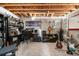 Finished basement area with exposed ceiling, concrete walls, carpet, and a built-in desk and workspace at 15353 E 98Th Pl, Commerce City, CO 80022