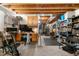 Large basement area featuring an exposed ceiling, concrete walls, work area, and storage shelves at 15353 E 98Th Pl, Commerce City, CO 80022