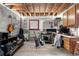 Basement features an exposed ceiling, concrete walls, carpet, and several guitars placed throughout at 15353 E 98Th Pl, Commerce City, CO 80022