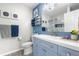 Bright and modern bathroom with a blue vanity, stylish sink, and coordinating decor at 15353 E 98Th Pl, Commerce City, CO 80022
