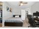Cozy bedroom featuring neutral walls, ceiling fan, and an adjoining bathroom for added convenience at 15353 E 98Th Pl, Commerce City, CO 80022