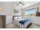 Comfortable bedroom with a large window, ceiling fan, natural light, and a guitar on the wall at 15353 E 98Th Pl, Commerce City, CO 80022