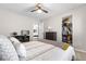 Comfortable bedroom with a bed, closet, ceiling fan, and a door that leads to another room at 15353 E 98Th Pl, Commerce City, CO 80022