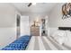 Cozy bedroom featuring wood paneling, a ceiling fan, closet access, and a well-placed chest of drawers at 15353 E 98Th Pl, Commerce City, CO 80022