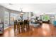 Open-concept dining room with a fireplace, hardwood floors, and a view of the living room at 15353 E 98Th Pl, Commerce City, CO 80022