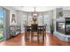 Light filled dining room with hardwood floors, fireplace and a decorative light fixture at 15353 E 98Th Pl, Commerce City, CO 80022