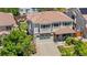 Aerial view of a charming two-story home with a brick facade, and an attached two-car garage at 15353 E 98Th Pl, Commerce City, CO 80022