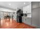 Open kitchen with wood floors, features stainless steel fridge and stairs to the second floor at 15353 E 98Th Pl, Commerce City, CO 80022
