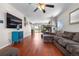 Spacious living room with a fireplace, hardwood floors, and comfortable seating at 15353 E 98Th Pl, Commerce City, CO 80022