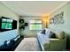 Comfortable living room with couch, TV, and window providing natural light at 15353 E 98Th Pl, Commerce City, CO 80022