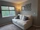 Cozy living room featuring a comfortable white sofa, decorative wall art, and natural light from a window at 15353 E 98Th Pl, Commerce City, CO 80022