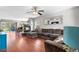Spacious living room with a fireplace, hardwood floors, and comfortable seating at 15353 E 98Th Pl, Commerce City, CO 80022