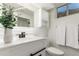 A modern bathroom features white vanity, vessel sink, black fixtures, decorative mirror, and towel bar at 6699 S Pennsylvania St, Centennial, CO 80121