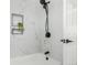 Close up of shower boasting luxurious marble tile and matte black hardware at 6699 S Pennsylvania St, Centennial, CO 80121