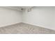 A finished basement bedroom featuring neutral carpet, bright white walls, and natural lighting at 6699 S Pennsylvania St, Centennial, CO 80121