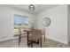 Cozy dining room featuring a round table, woven chairs, and a sliding glass door with a view of the backyard at 6699 S Pennsylvania St, Centennial, CO 80121