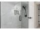 This walk-in shower features marbled walls, new shower head, black fixtures, and mosaic tile floor at 6699 S Pennsylvania St, Centennial, CO 80121