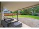 Covered back patio with furniture overlooking a spacious and well-maintained backyard at 1420 S Leyden St, Denver, CO 80224