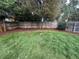 Fenced backyard with grass and fresh mulch landscaping at 1420 S Leyden St, Denver, CO 80224