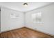 A bedroom with wood floors and natural light from two windows with blinds at 1420 S Leyden St, Denver, CO 80224