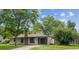 Charming single-story home with a brick chimney, attached garage, and well-manicured lawn at 1420 S Leyden St, Denver, CO 80224