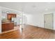 Bright living room featuring hardwood floors, white walls, and an open layout to the kitchen at 1420 S Leyden St, Denver, CO 80224