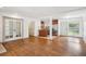 Open-concept living area with hardwood floors, fireplace, and access to the kitchen at 1420 S Leyden St, Denver, CO 80224