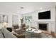 Cozy living room featuring a fireplace, hardwood floors, and natural light at 1420 S Leyden St, Denver, CO 80224