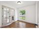 Office space with French doors, hardwood floors, and a large window at 1420 S Leyden St, Denver, CO 80224