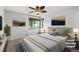 Cozy bedroom featuring a large window, ceiling fan, and neutral decor for a tranquil feel at 420 Dudley St, Lakewood, CO 80226