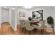 Formal dining room with wood floors, seating for six, and an open view to the living room at 420 Dudley St, Lakewood, CO 80226