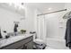 Bathroom with a granite counter, white sink, shower with white curtain and black fixtures at 20000 E 40Th Ave # 4, Denver, CO 80249