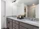 Bathroom featuring a double vanity with granite countertop, two sinks and large mirror at 20000 E 40Th Ave # 4, Denver, CO 80249