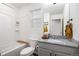 Bright bathroom with a tub and shower, white vanity with granite countertop and single sink at 20000 E 40Th Ave # 4, Denver, CO 80249