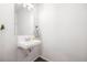 Powder room featuring a pedestal sink with faucet and modern fixtures at 20000 E 40Th Ave # 4, Denver, CO 80249