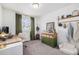 Cozy bedroom with neutral colors, features a desk, shelves and window with green curtains at 20000 E 40Th Ave # 4, Denver, CO 80249
