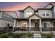 Charming townhouse featuring stone accents, covered porch, and landscaped front yard at 20000 E 40Th Ave # 4, Denver, CO 80249