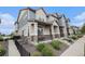 Side angle of a charming townhouse featuring a covered porch and manicured landscaping at 20000 E 40Th Ave # 4, Denver, CO 80249