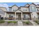 Inviting townhouse exterior with a cozy front porch and well-maintained landscaping at 20000 E 40Th Ave # 4, Denver, CO 80249