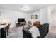 Finished basement living area with a TV, sofa, leather chair, desk and window at 20000 E 40Th Ave # 4, Denver, CO 80249