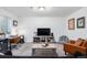 Finished basement living area with a TV, sofa, leather chair, desk, and window at 20000 E 40Th Ave # 4, Denver, CO 80249